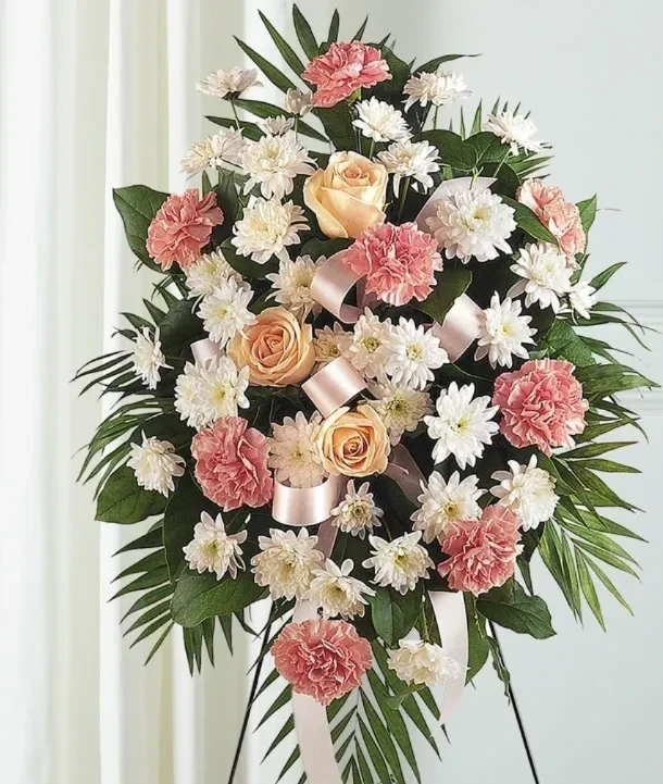 Soft white and cream sympathy flower arrangement with greenery