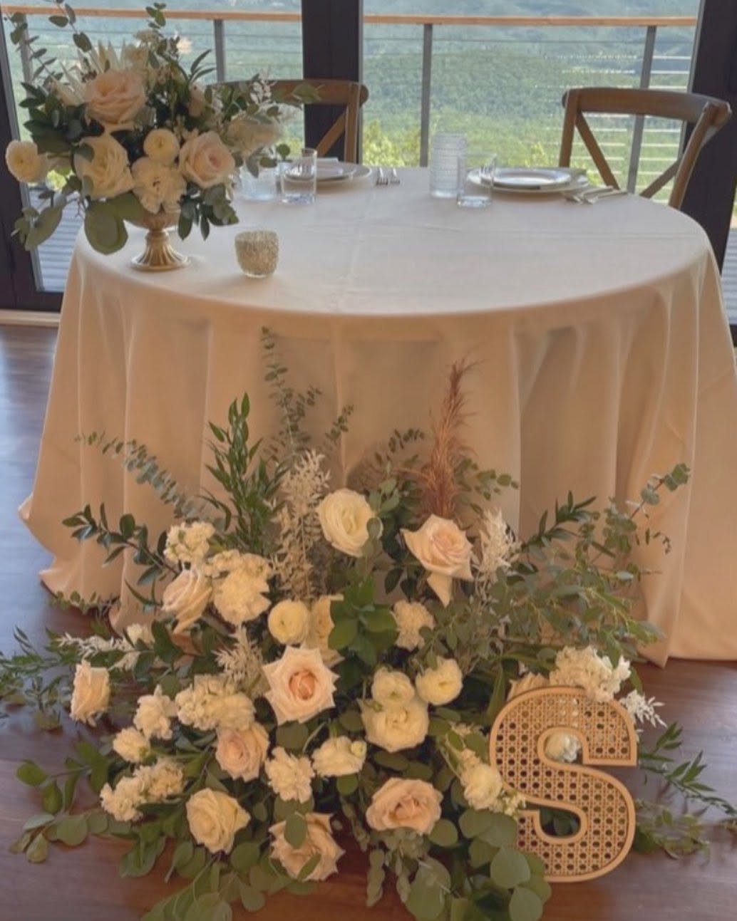 Sweetheart table with lush blush rose and greenery floor arrangement